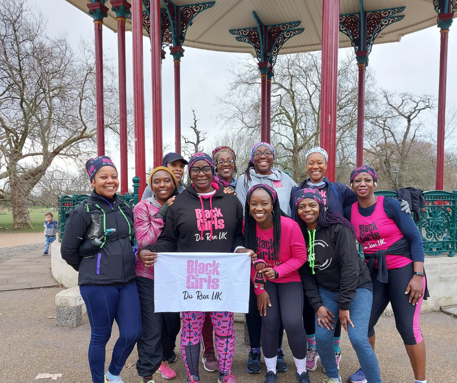 An all women/black running club members taking a group photo