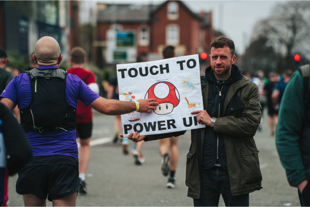 A marathon supporter with a sign