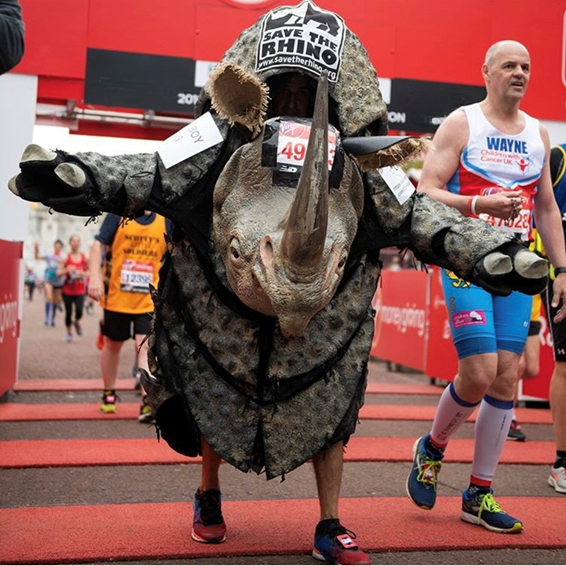 Man running marathon dressed as a rhino.
